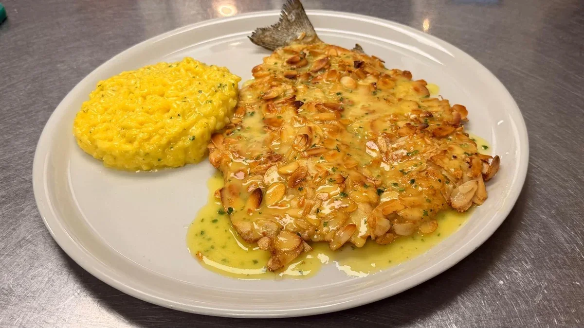 Pan-cooked trout fillet with sliced almonds and saffron risotto at Davanti
