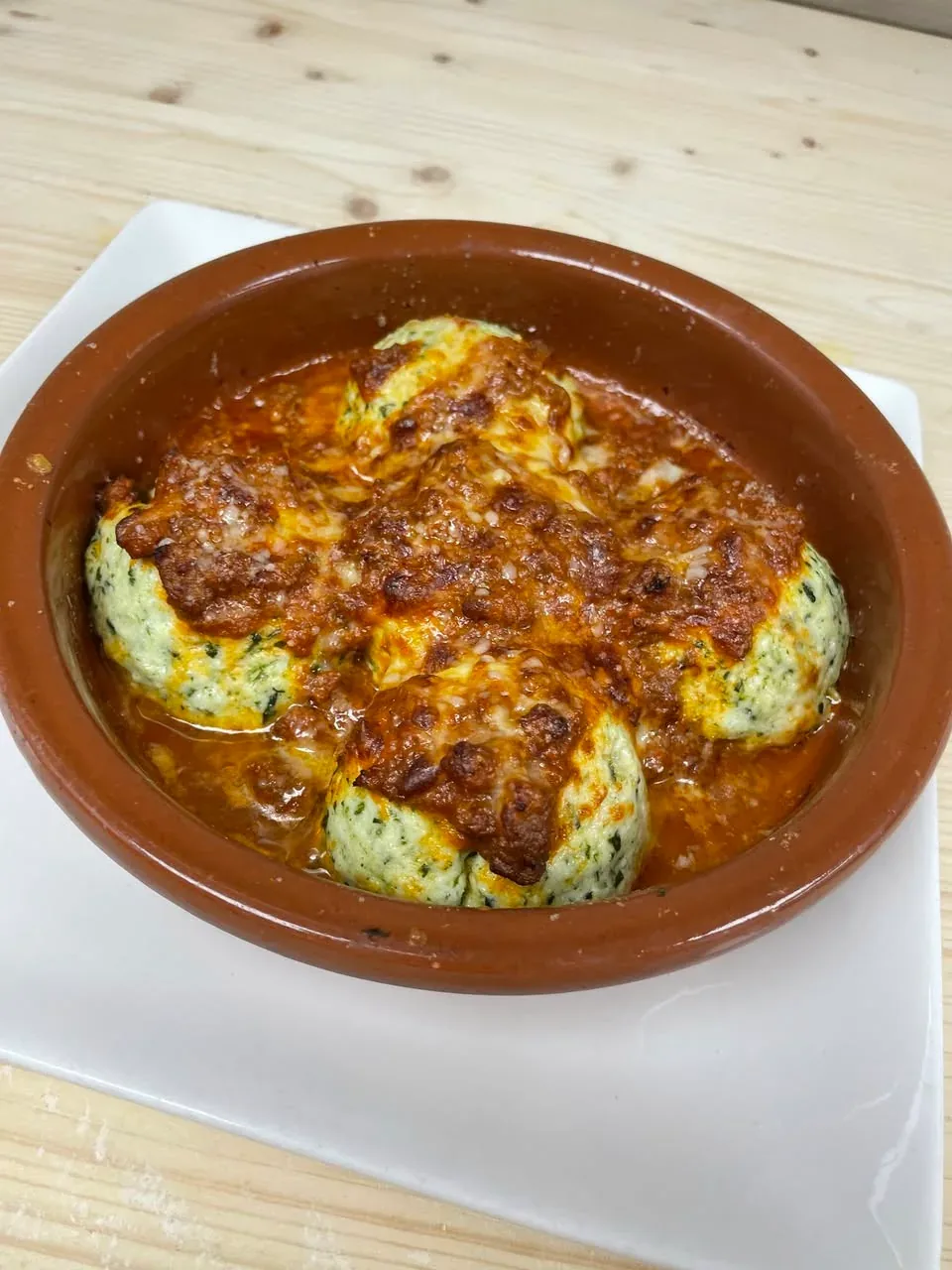 Gratinéed ricotta-and-spinach gnudi with Bolognese sauce at Davanti