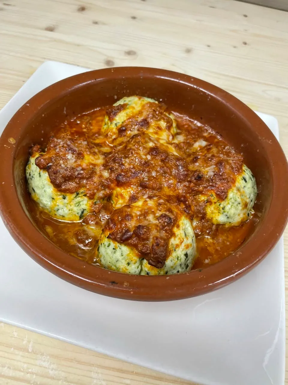Gratinéed ricotta-and-spinach gnudi with Bolognese sauce at Davanti