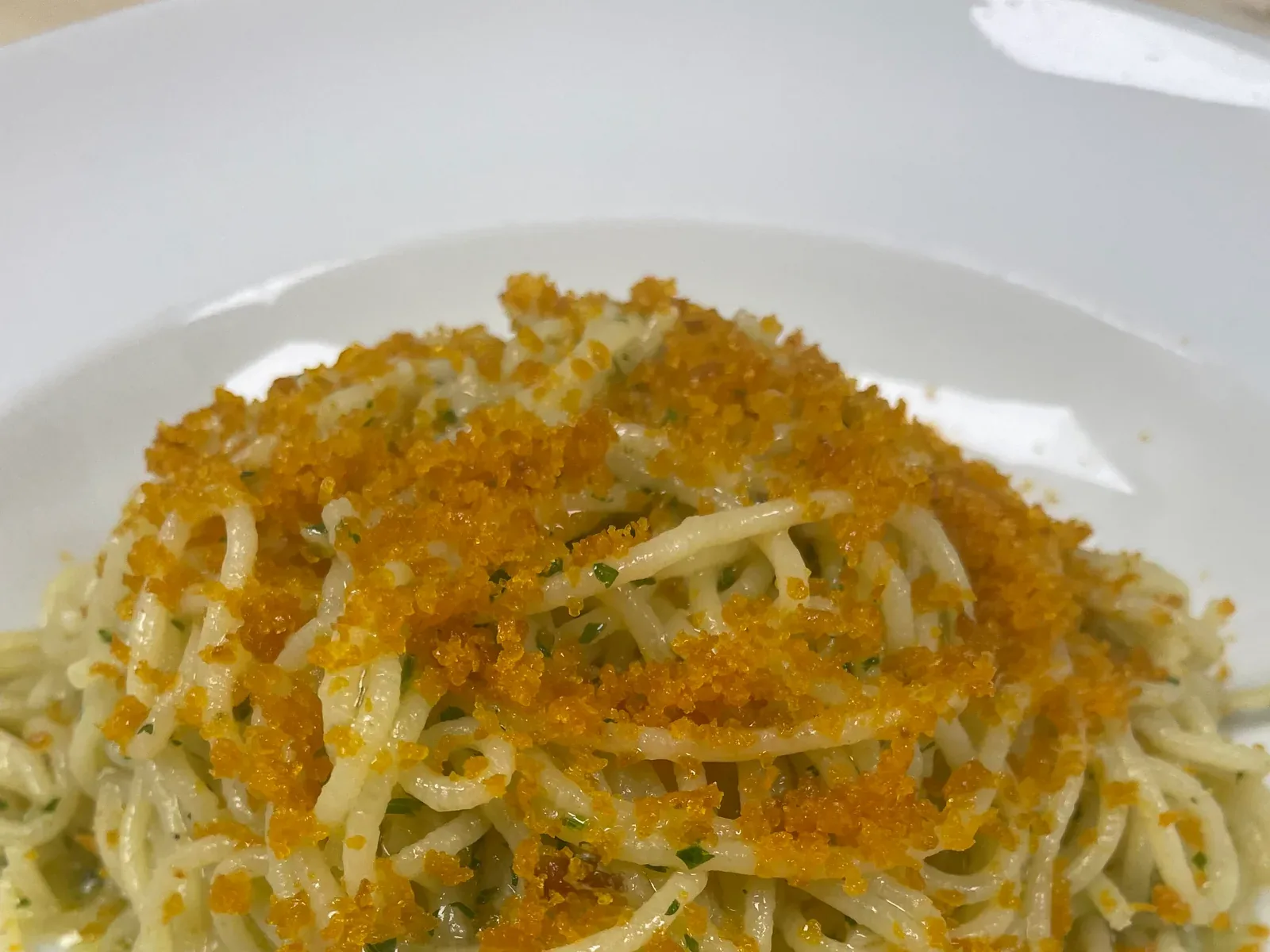 Spaghetti topped generously with grated bottarga and herbs at Davanti