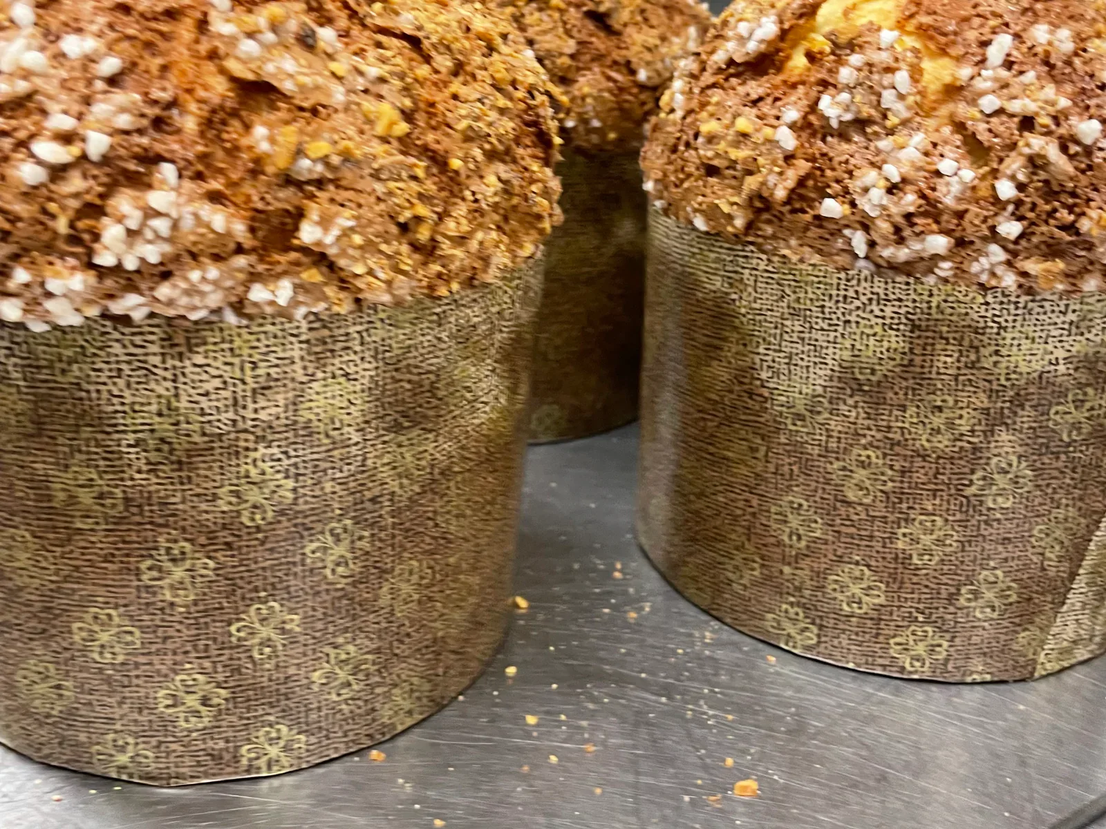 Several finished panettoni on a stainless-steel worktable in Davanti’s kitchen