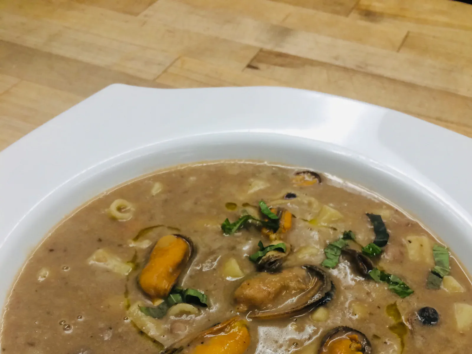 A bowl of pasta and bean soup topped with mussels at Davanti
