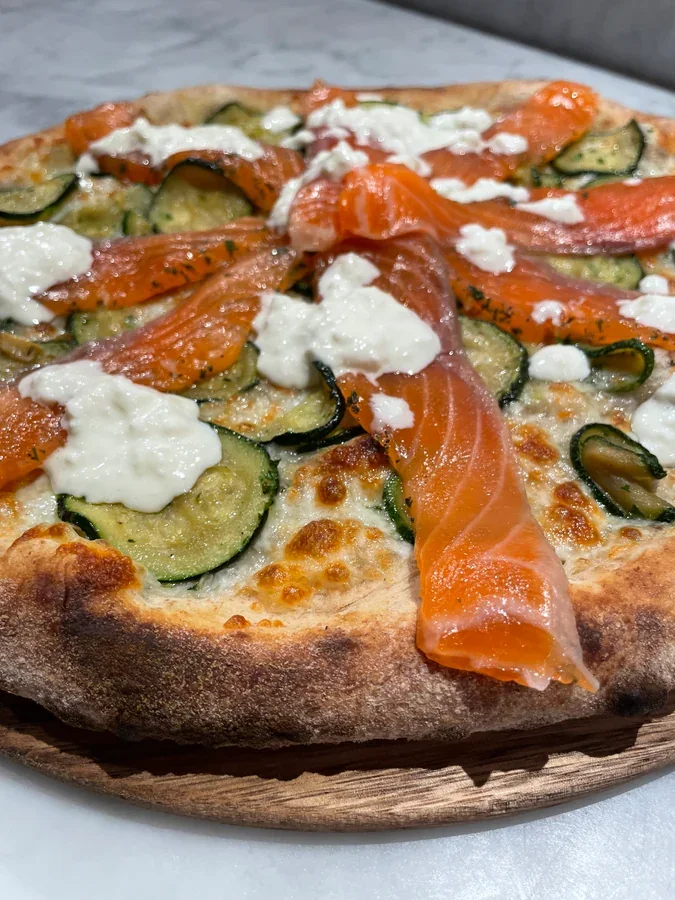 Hero archive view of Pizza con Salmone, Stracciatella e Zucchine plated at Davanti