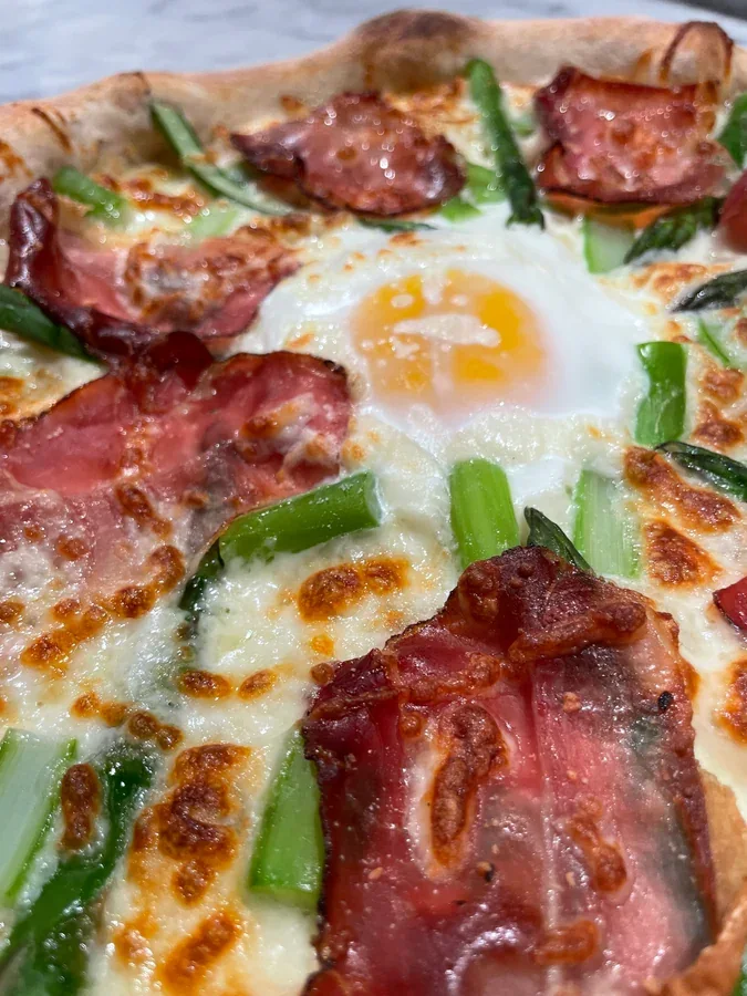 Hero archive view of Pizza con Taleggio, Speck, Asparagi e Uovo plated at Davanti