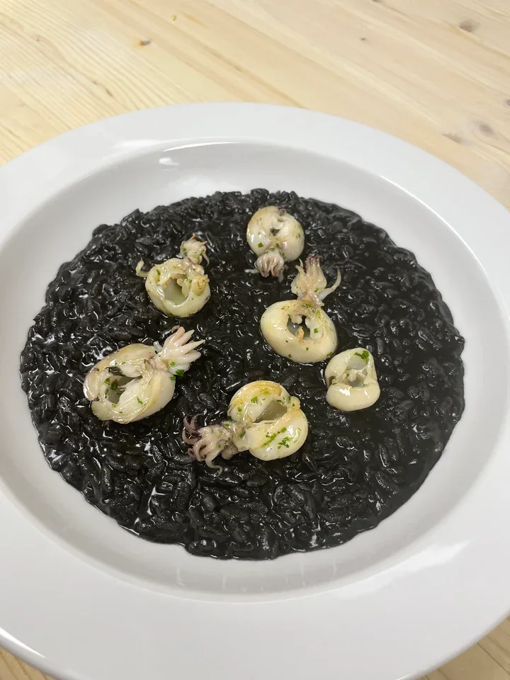 Archive view of Risotto al Nero di Seppia alla Veneziana plated at Davanti