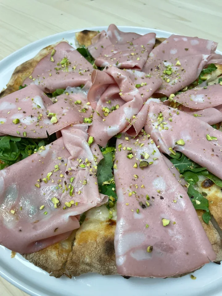 Archive view of Pizza con Mortadella, Squacquerone e Pistacchio plated at Davanti