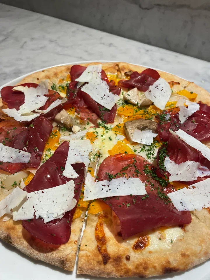 Archive view of Pizza con Bresaola, Aged Truffle Ricotta, Porcini e Zucca plated at Davanti