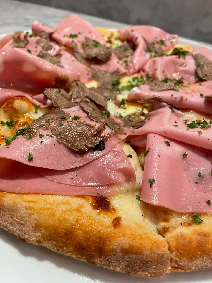 Archive view of Pizza con Mortadella, Squacquerone, e Tartufo Nero Invernale plated at Davanti