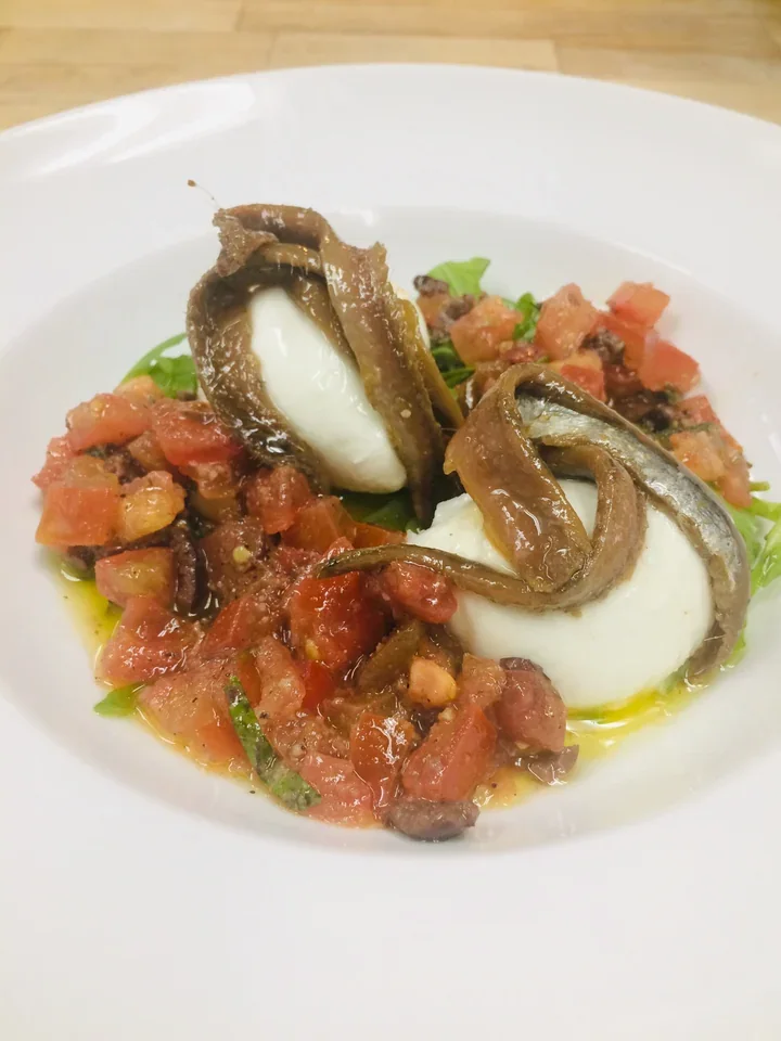 Archive view of Mozzarella di Bufala Acciughe del Mediterraneo e Focaccia Bread plated at Davanti