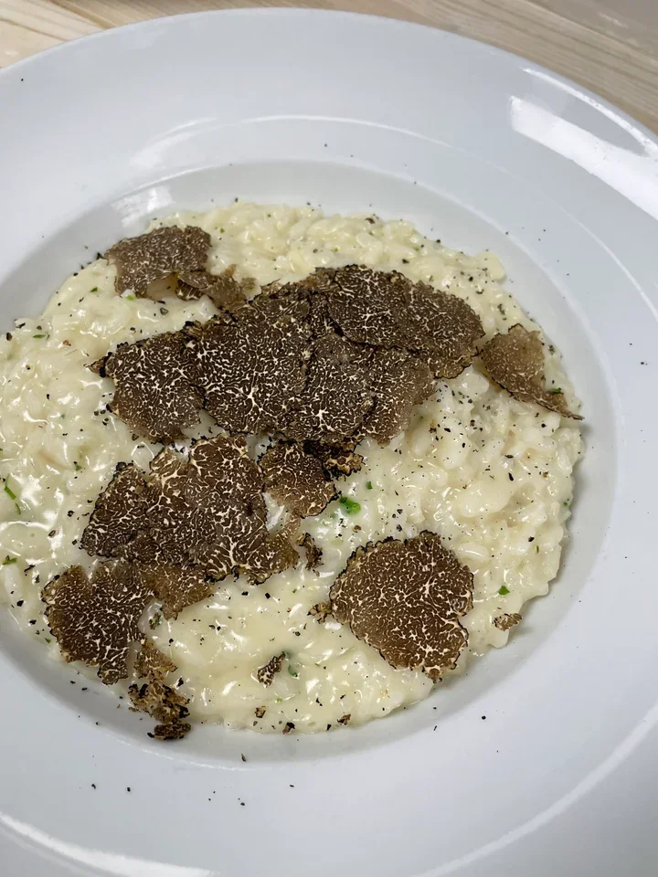 Archive view of Risotto al Tartufo Nero e Taleggio plated at Davanti