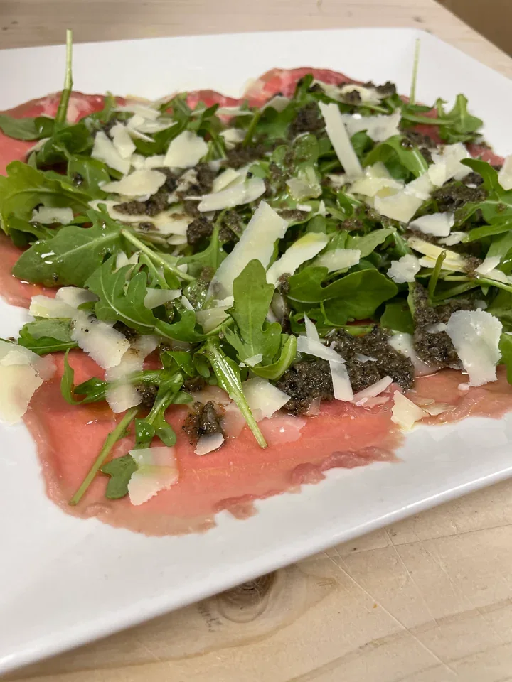Archive view of Carpaccio di Manzo con Parmigiano e Rucola plated at Davanti
