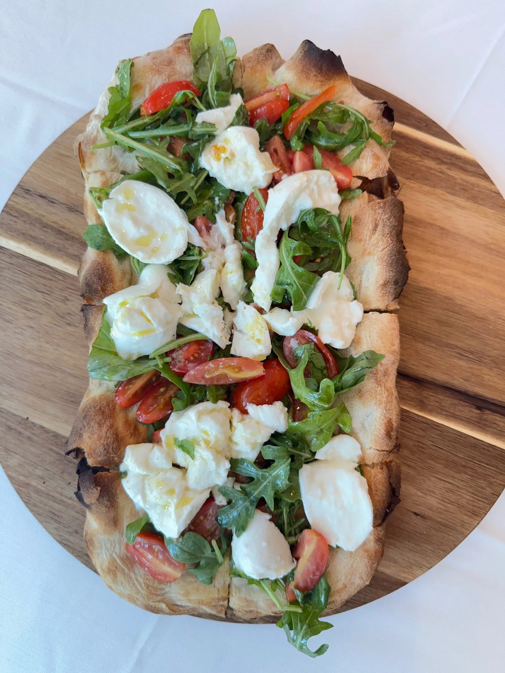 Davanti pinsa topped with burrata and tomatoes