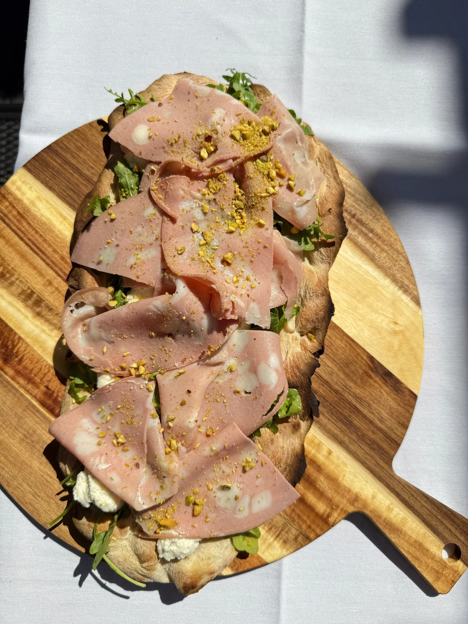 Davanti pinsa with mortadella and pistachio