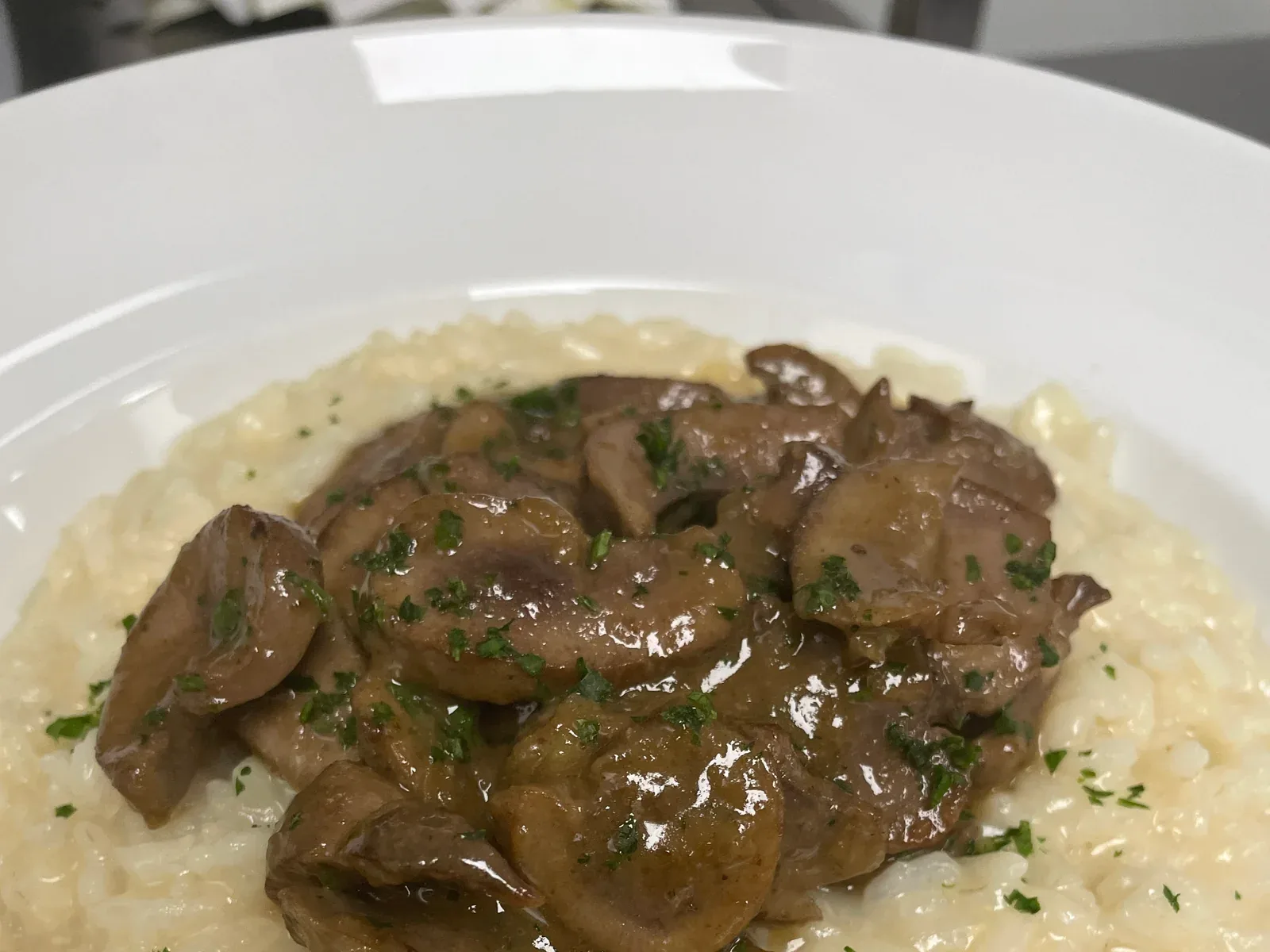Creamy risotto topped with a savory garnish and herbs at Davanti