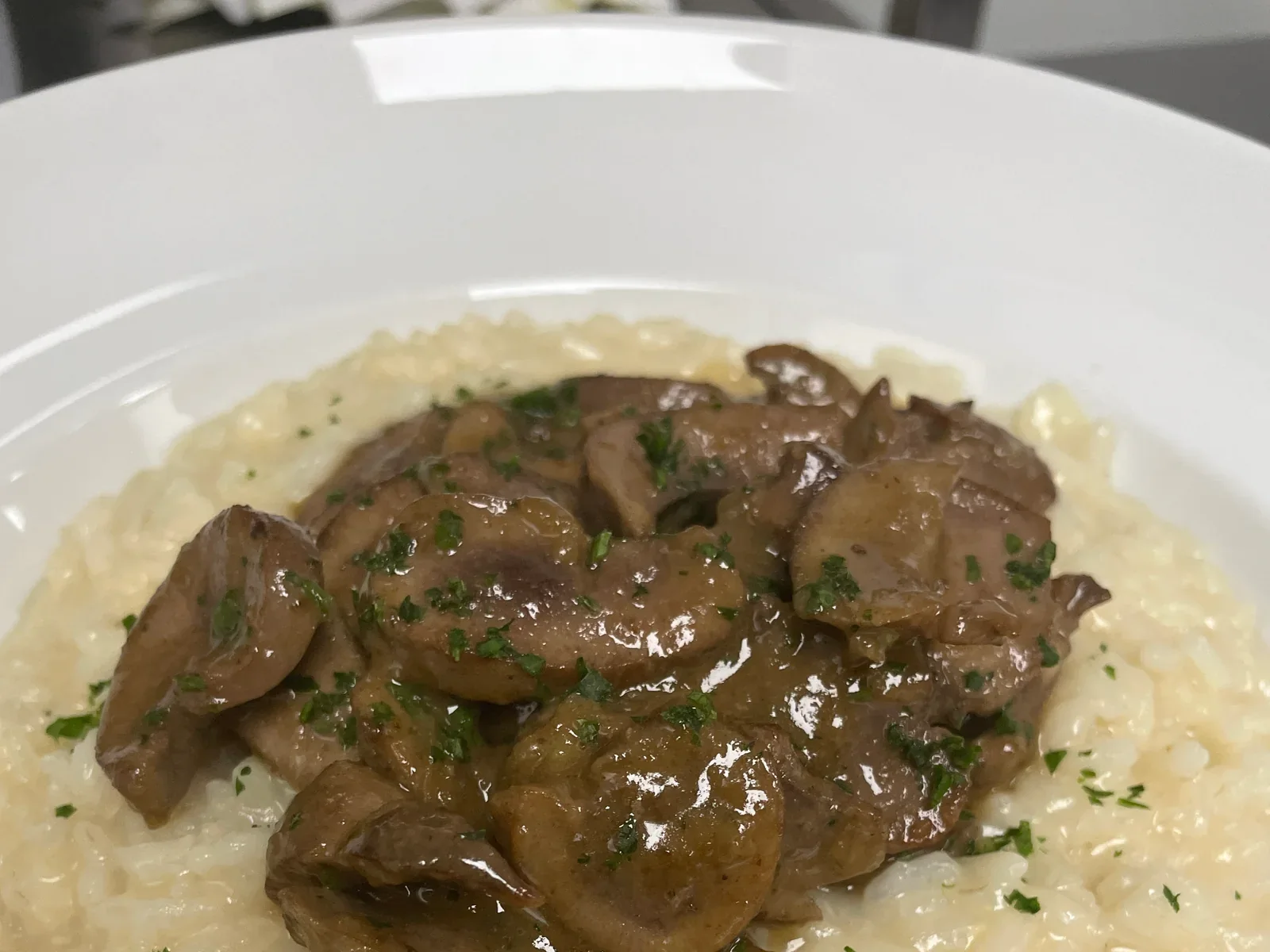 Creamy risotto topped with a savory garnish and herbs at Davanti